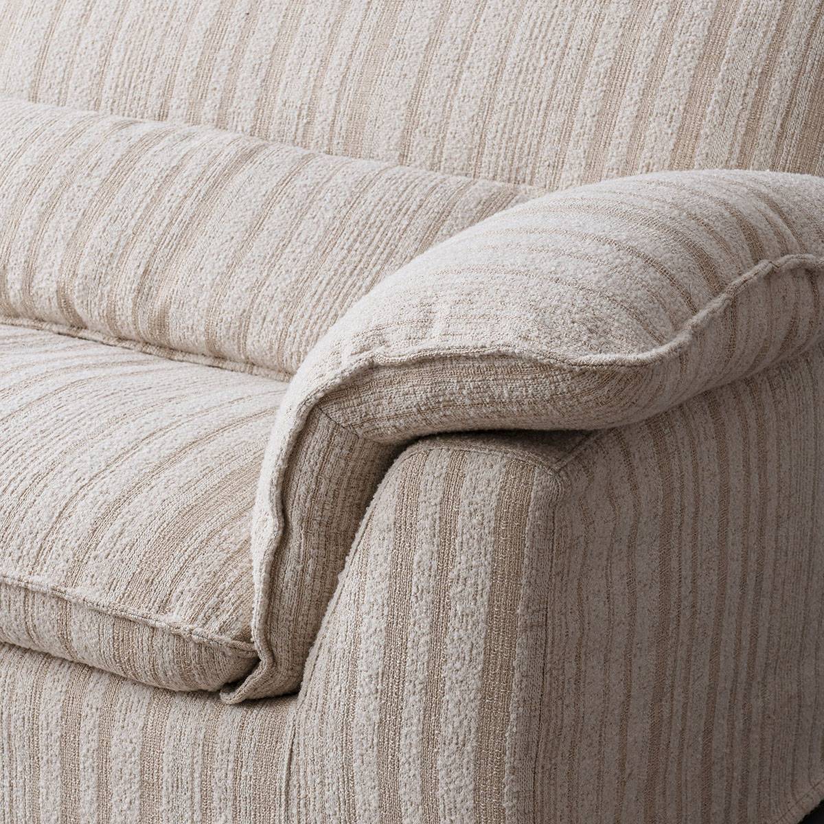 Close-up detail of the sofa's armrest and seat cushion showing the fabric texture.