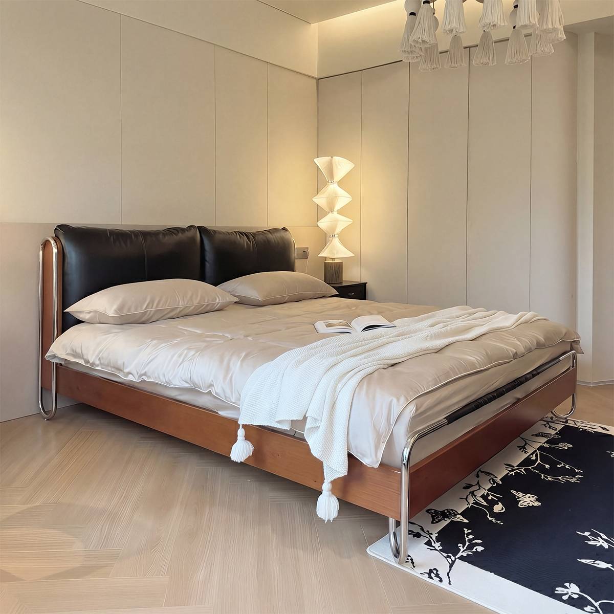 Bed styled with white bedding and a floor lamp in a minimalist room