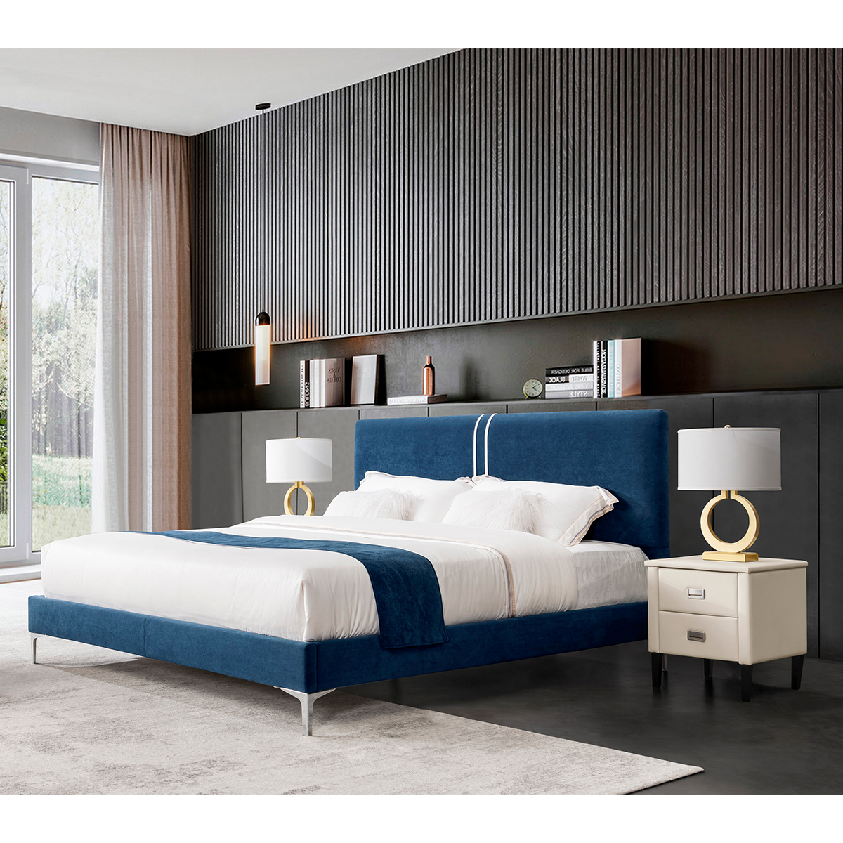 Blue velvet upholstered bed in a modern bedroom setting with white bedding and gold accents.