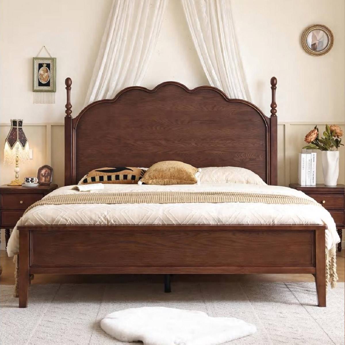 Front view of the bed showing the scalloped headboard and bedside tables