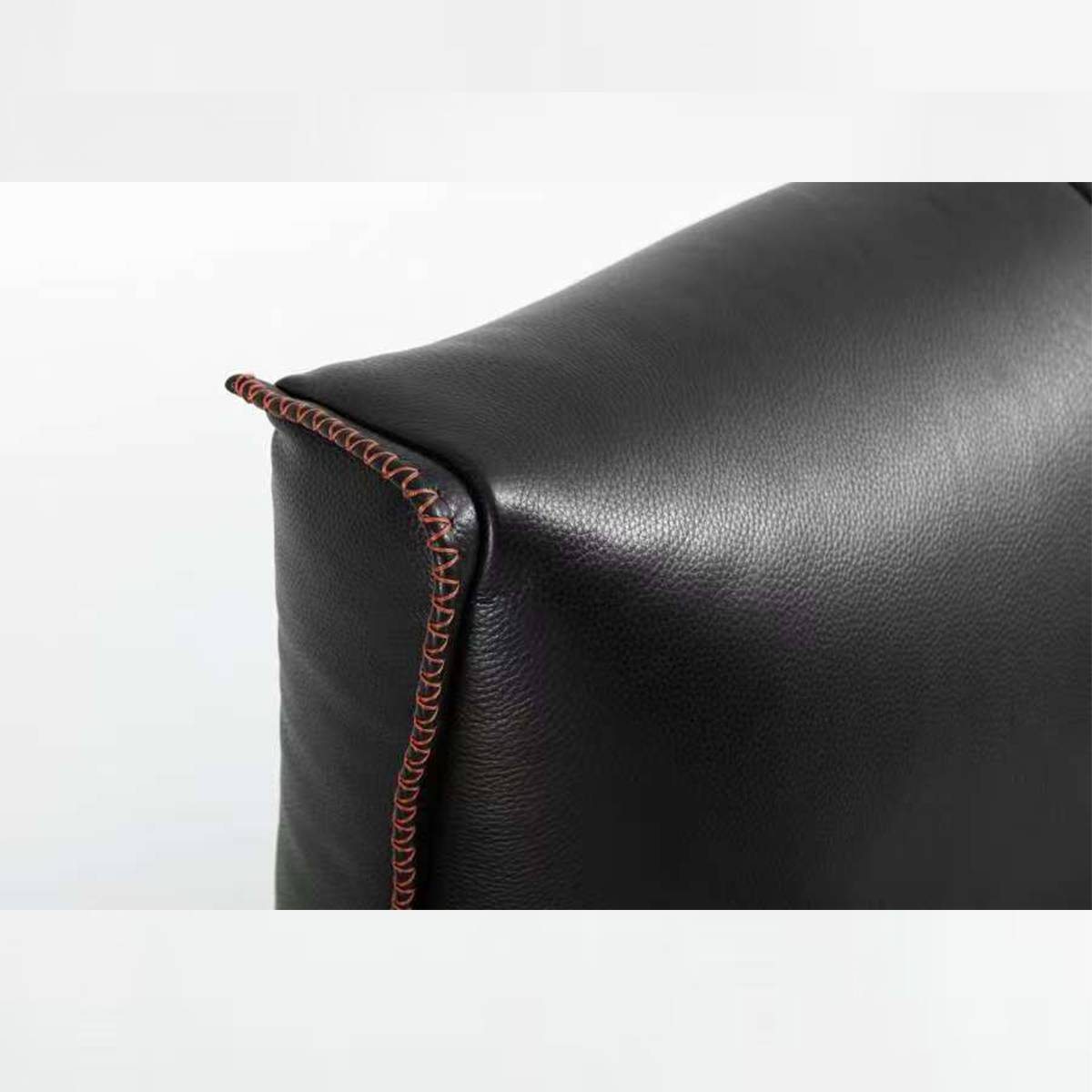 Close-up detail of the black leather headboard stitching