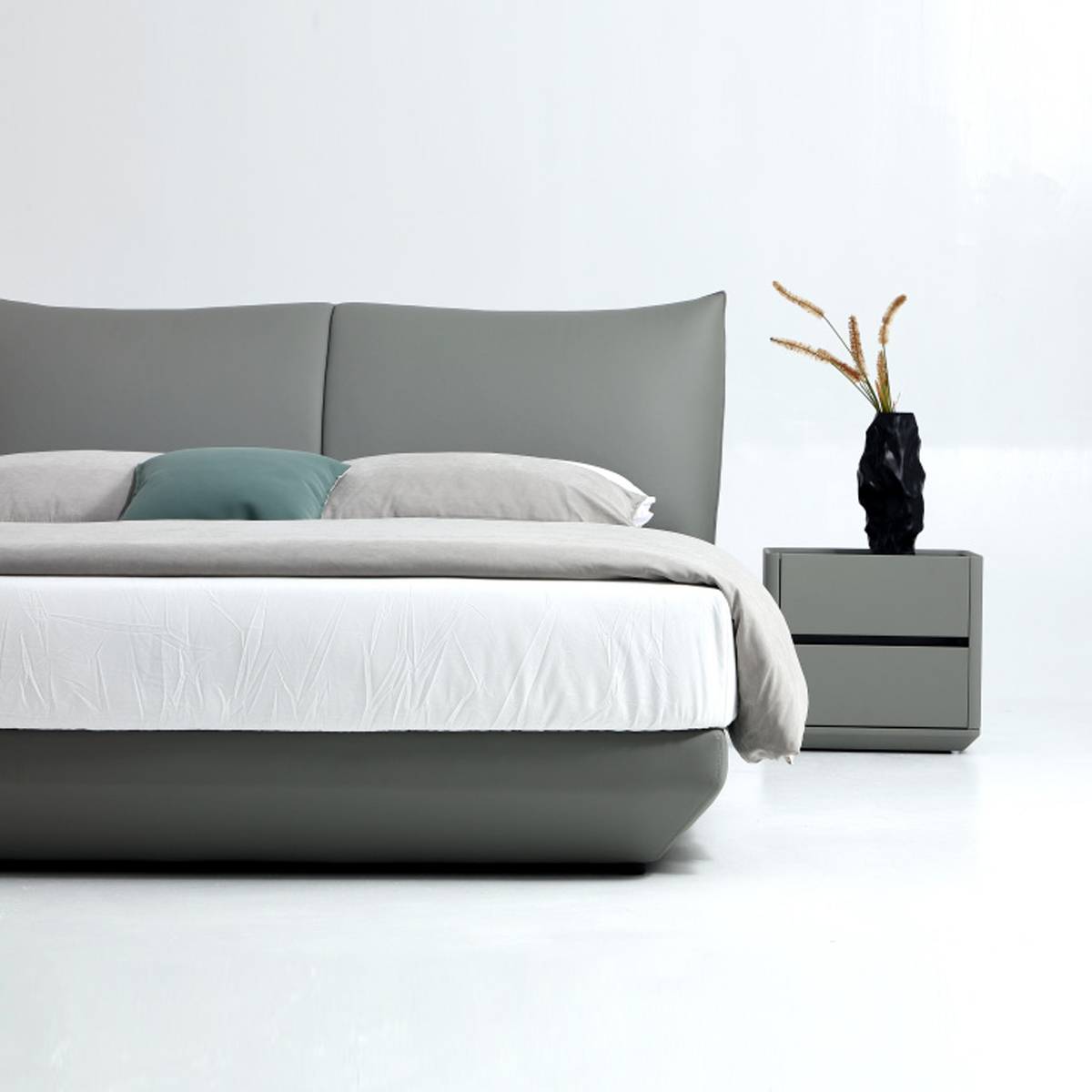 Close-up detail of the bed frame, mattress, and bedside table