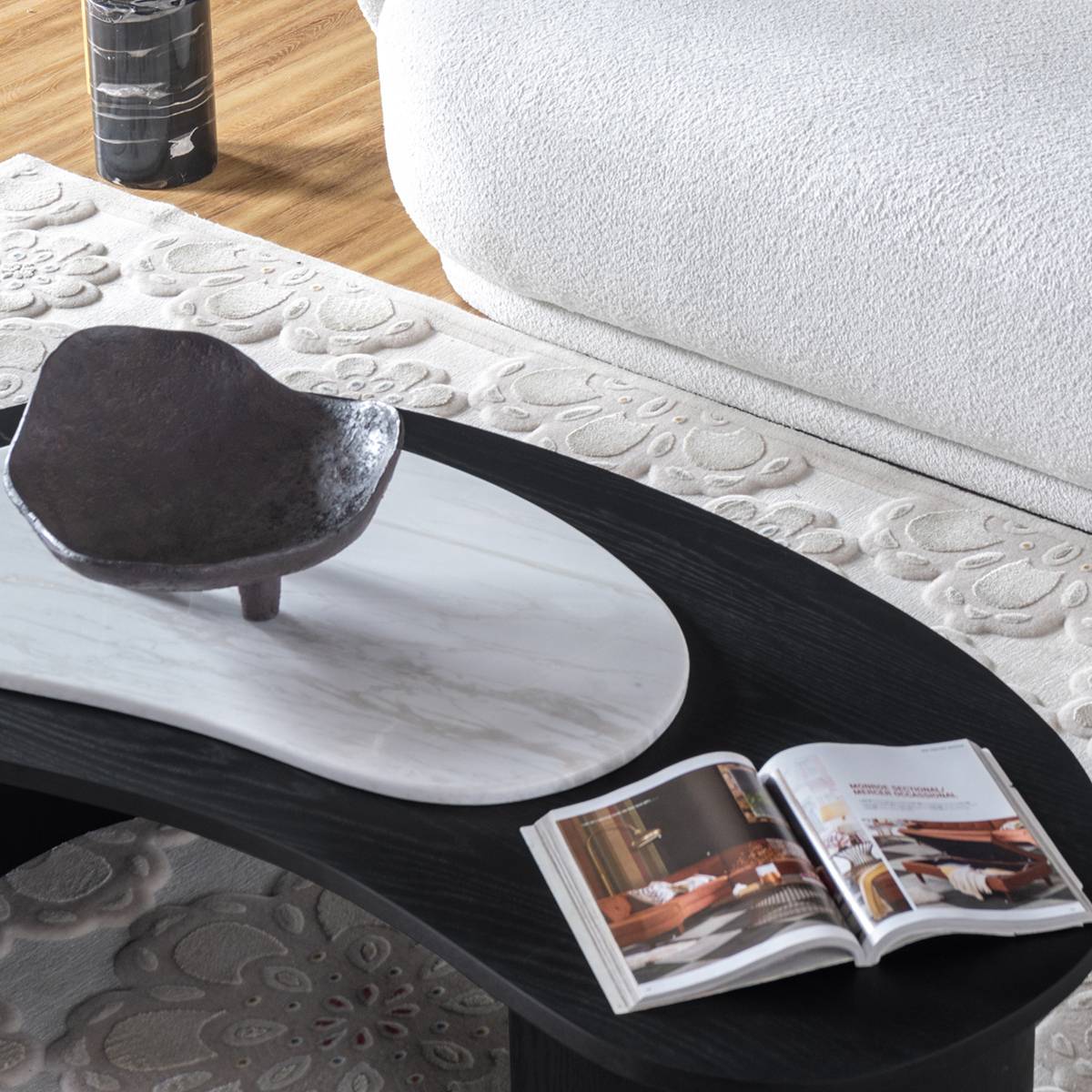 Close up of the coffee table surface with a decorative bowl and magazine