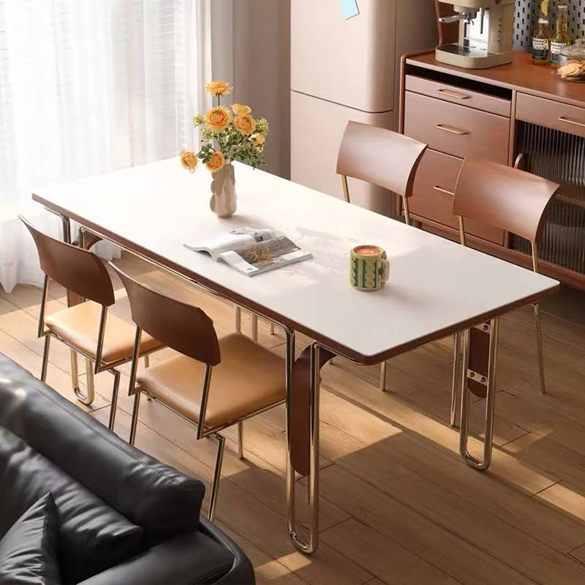 White dining table with brown leather chairs in a bright dining area