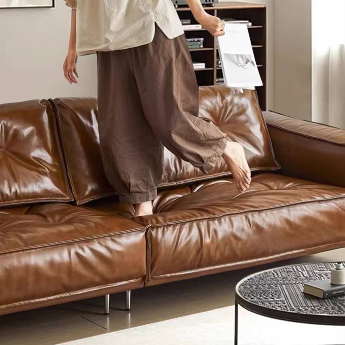 Close-up of a person sitting on the sofa showing leather texture