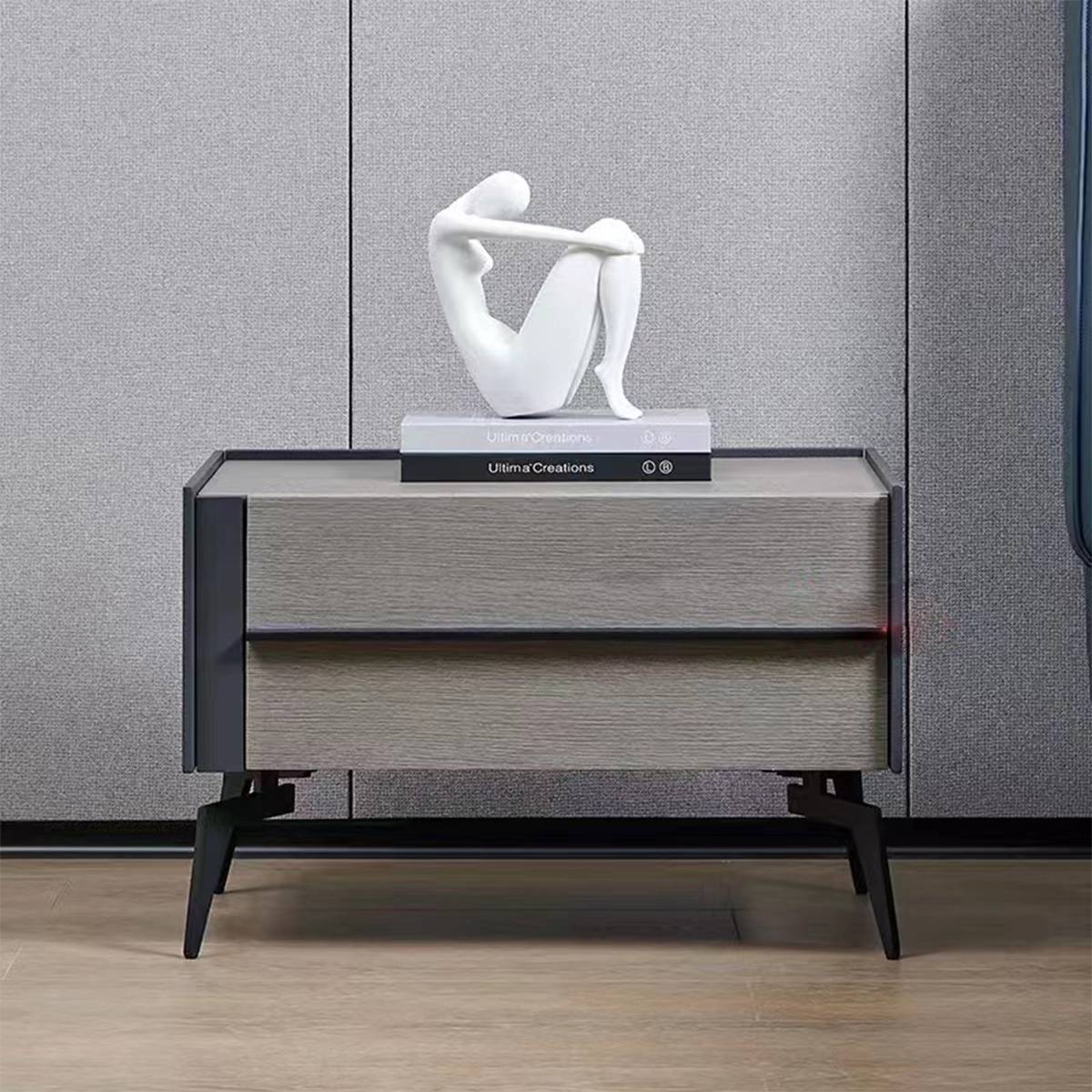 The bedside cabinet placed in a bedroom setting against a grey wall