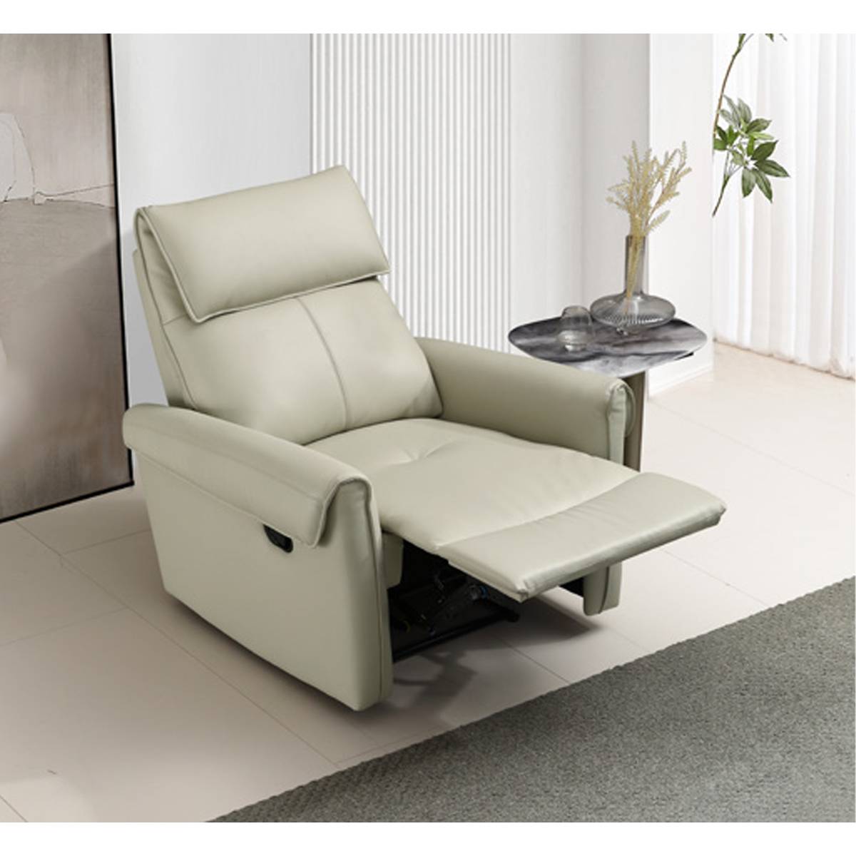 Side view of the beige leather recliner chair in a reclined position showing the extended footrest