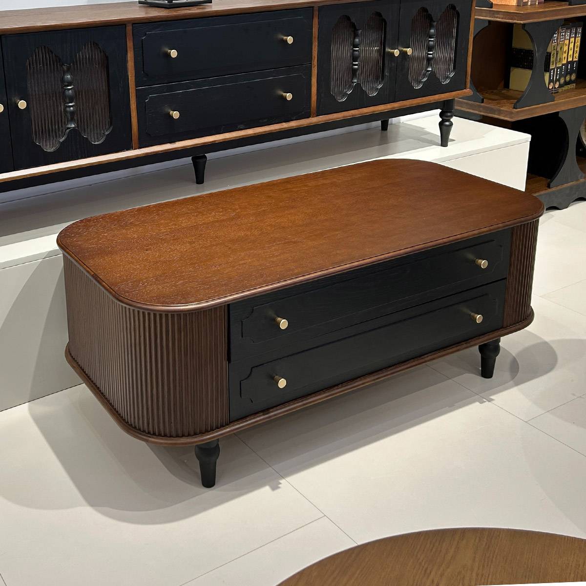 Close up of coffee table showing fluted details and drawers