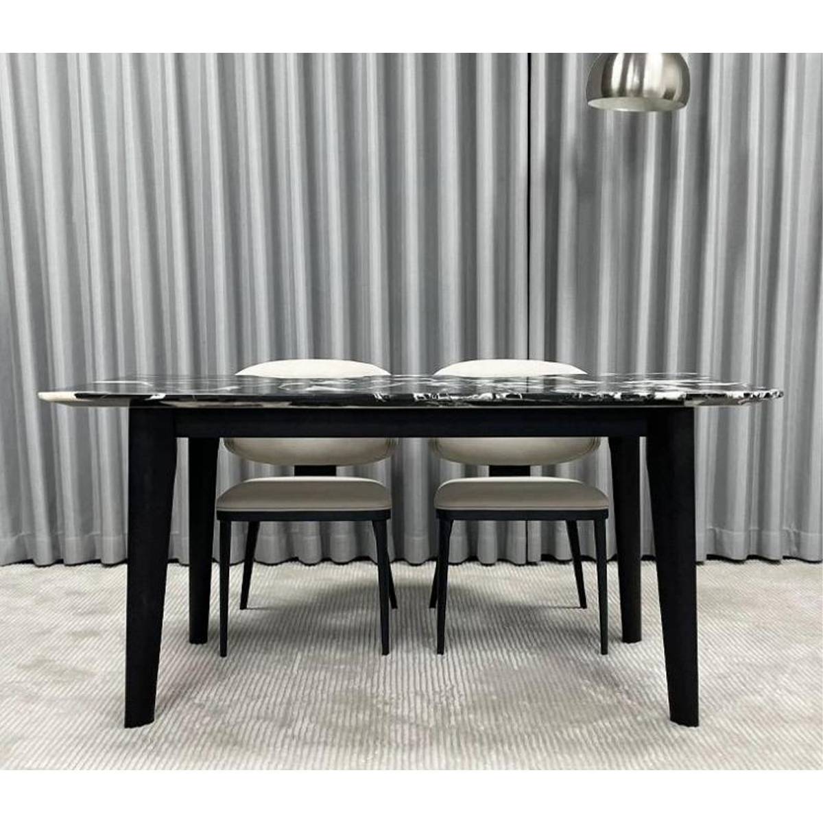 Front view of the Bulgari Black marble dining table showing the stone pattern and solid wood legs