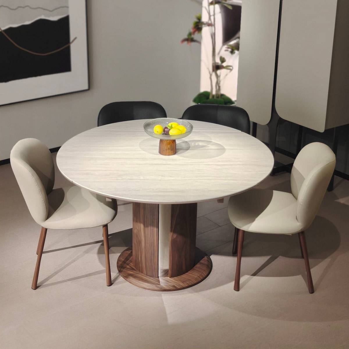 Dining table set with chairs and a fruit bowl, demonstrating the table in a dining room setting