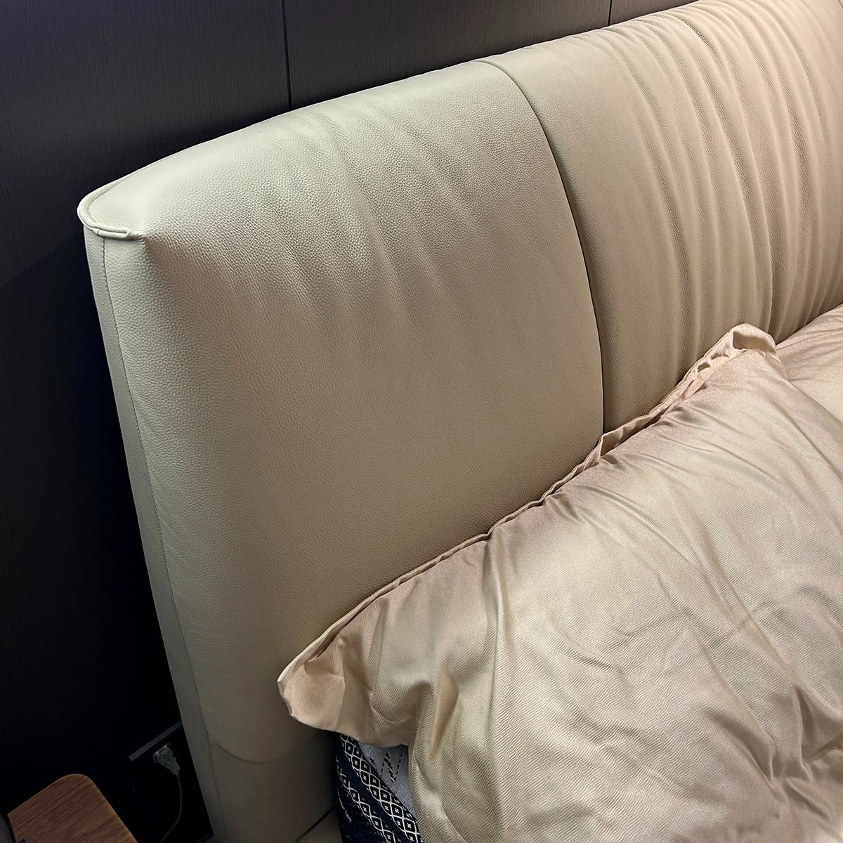 Close-up detail of the top-grain leather texture on the headboard.