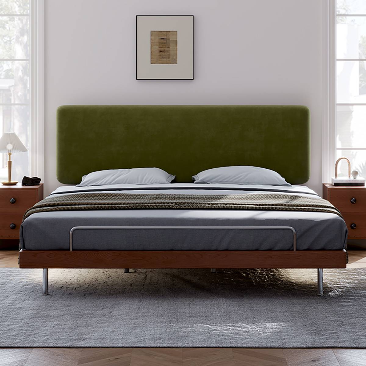 Front view of the bed showing the wide green velvet headboard and metal legs