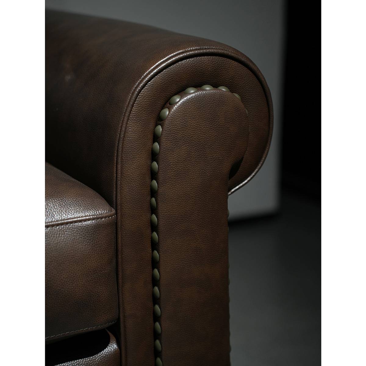 Detail shot of the rolled armrest with decorative nailhead trim