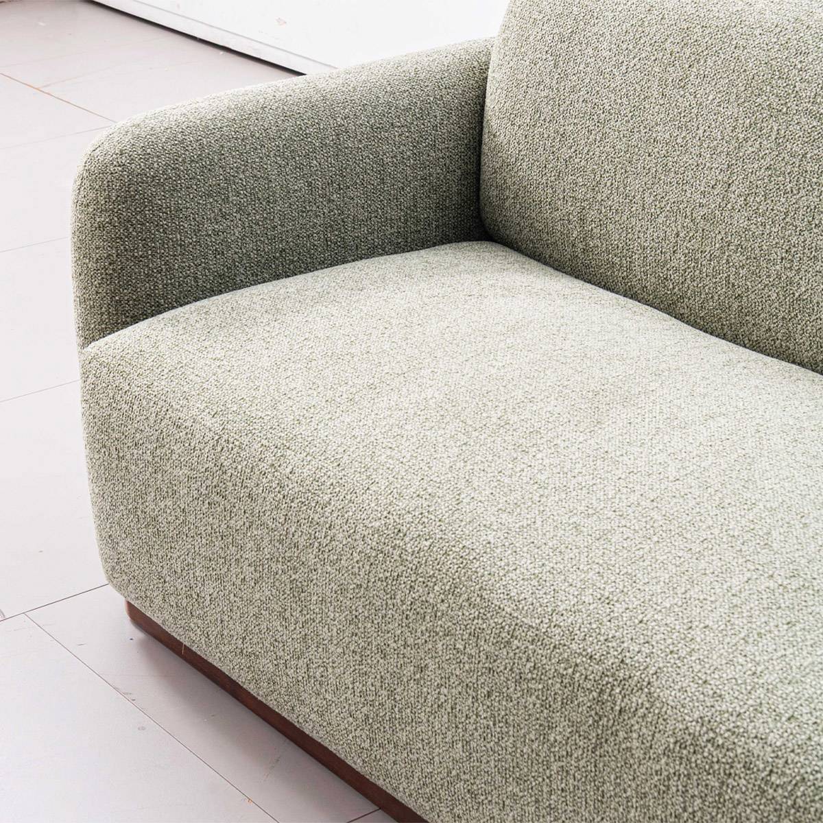 Close-up detail of the sofa fabric texture and armrest