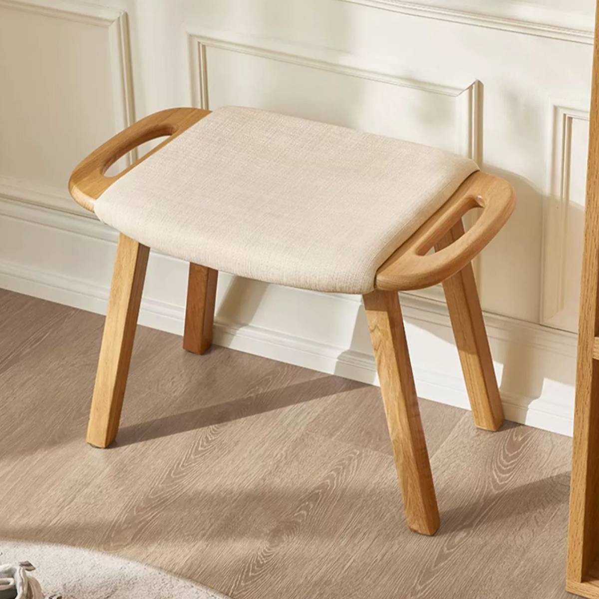 Top-down angled view showing the fabric texture and wooden handles of the stool