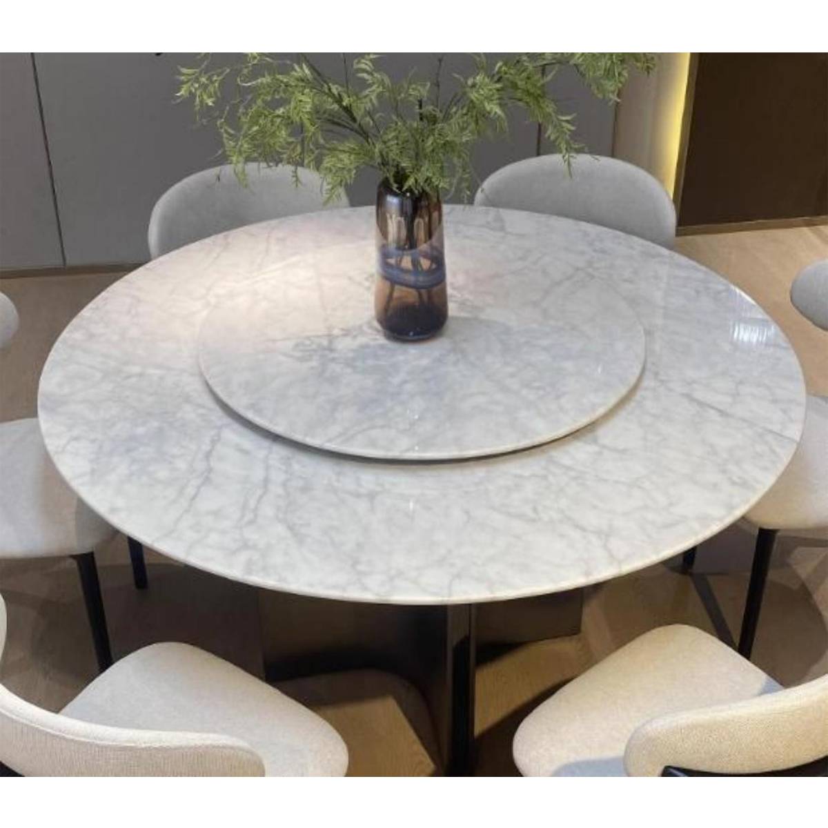 Top-down view of the dining table showing the marble texture and surrounding chairs.
