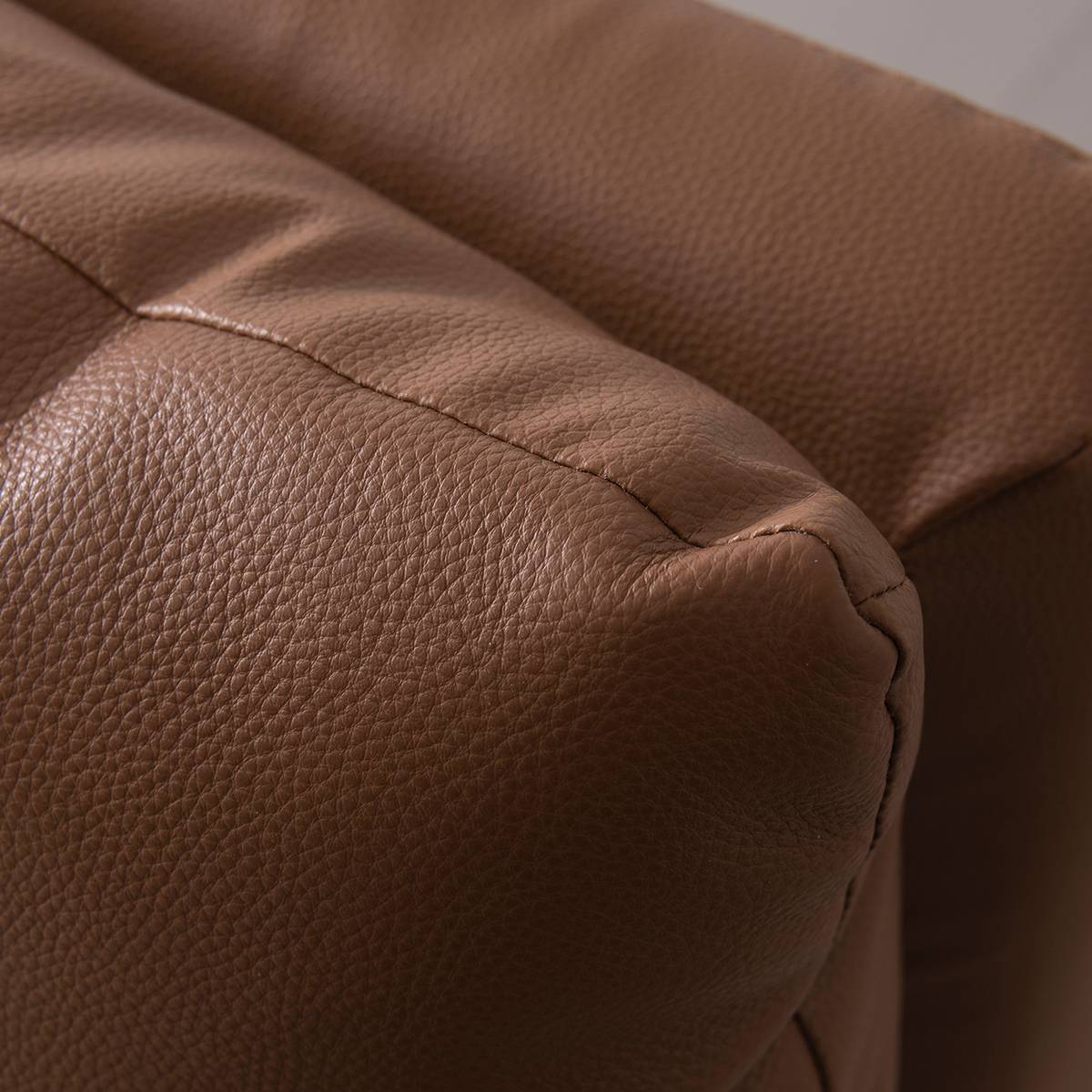 Detail shot of the textured brown leather upholstery