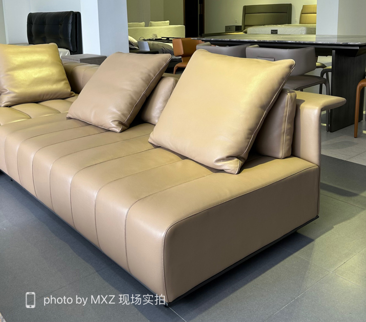 Beige leather version of the sofa showing the tufted back and seat