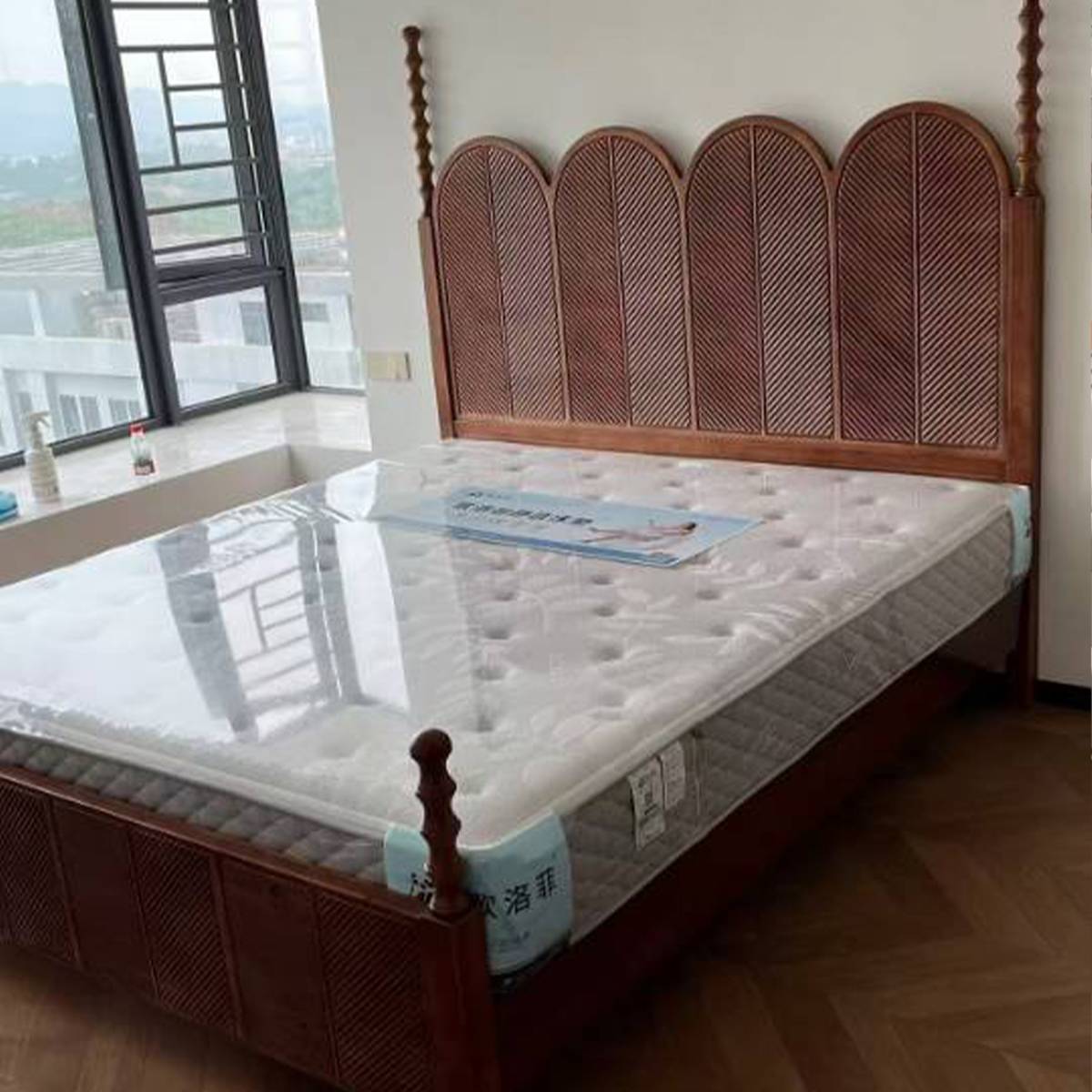 Close-up view of the bed frame and mattress showing the wood texture