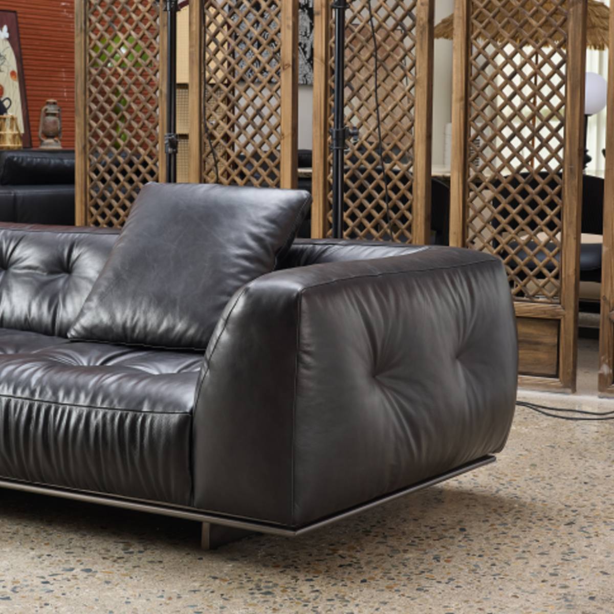 Close-up detail of the sofa armrest and leather texture
