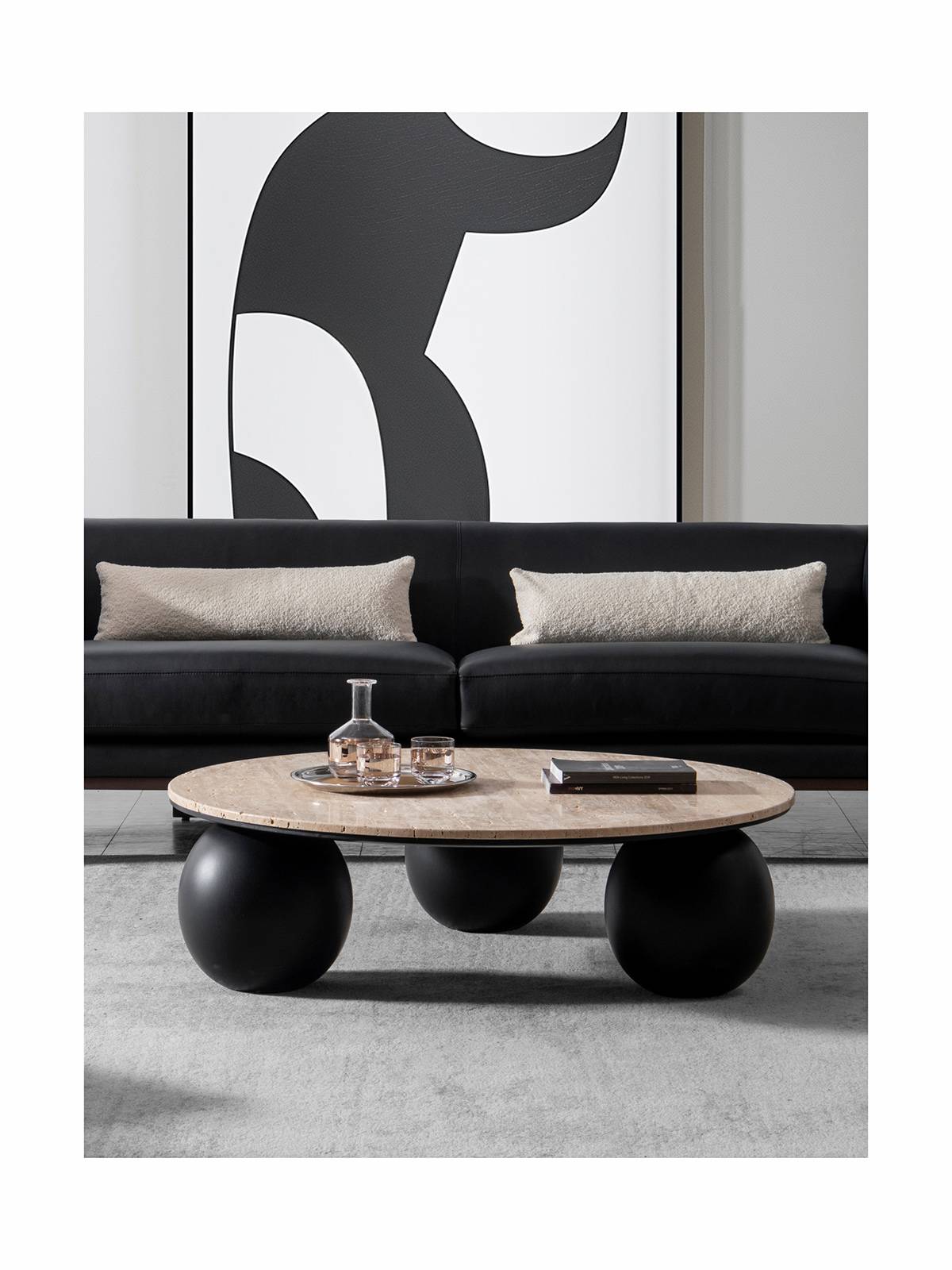 Lifestyle shot of the Makati coffee table in a living room setting with a black sofa.