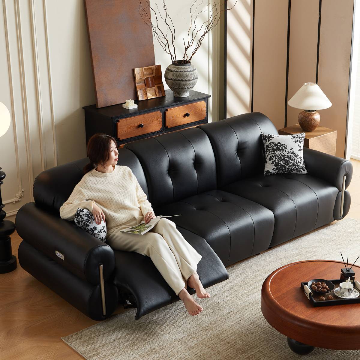 Full view of black leather functional sofa with recliner extended