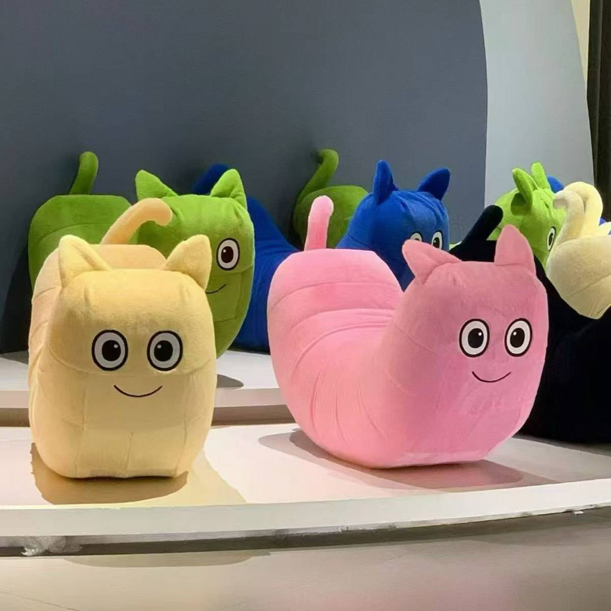 Collection of colorful caterpillar chairs in various poses