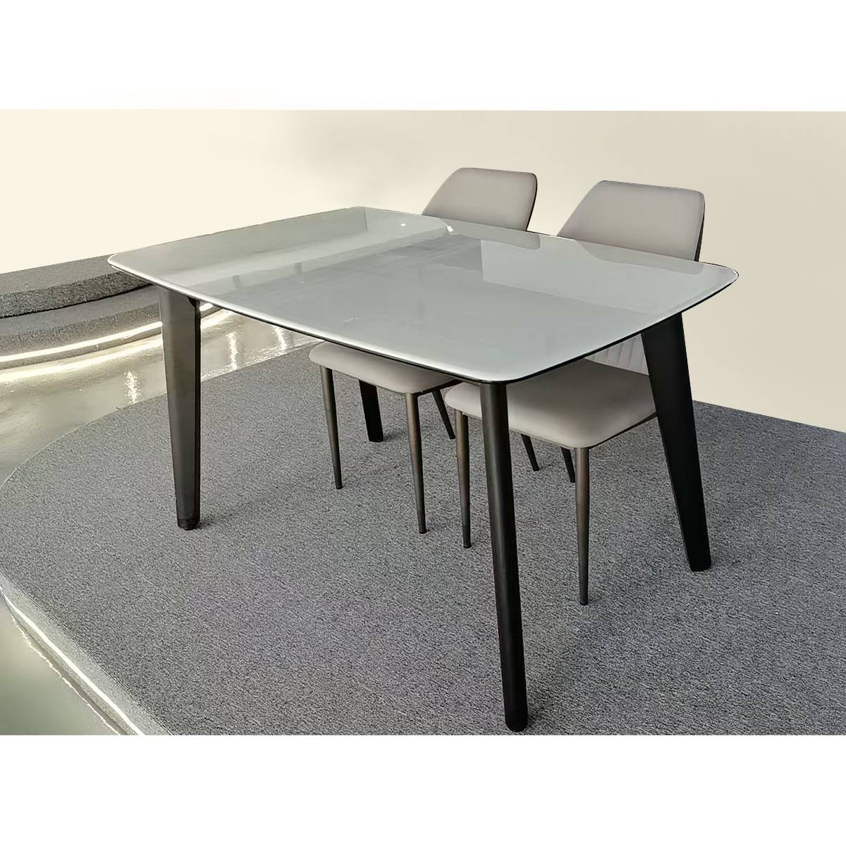 Side view of the marble dining table with grey chairs on a grey rug