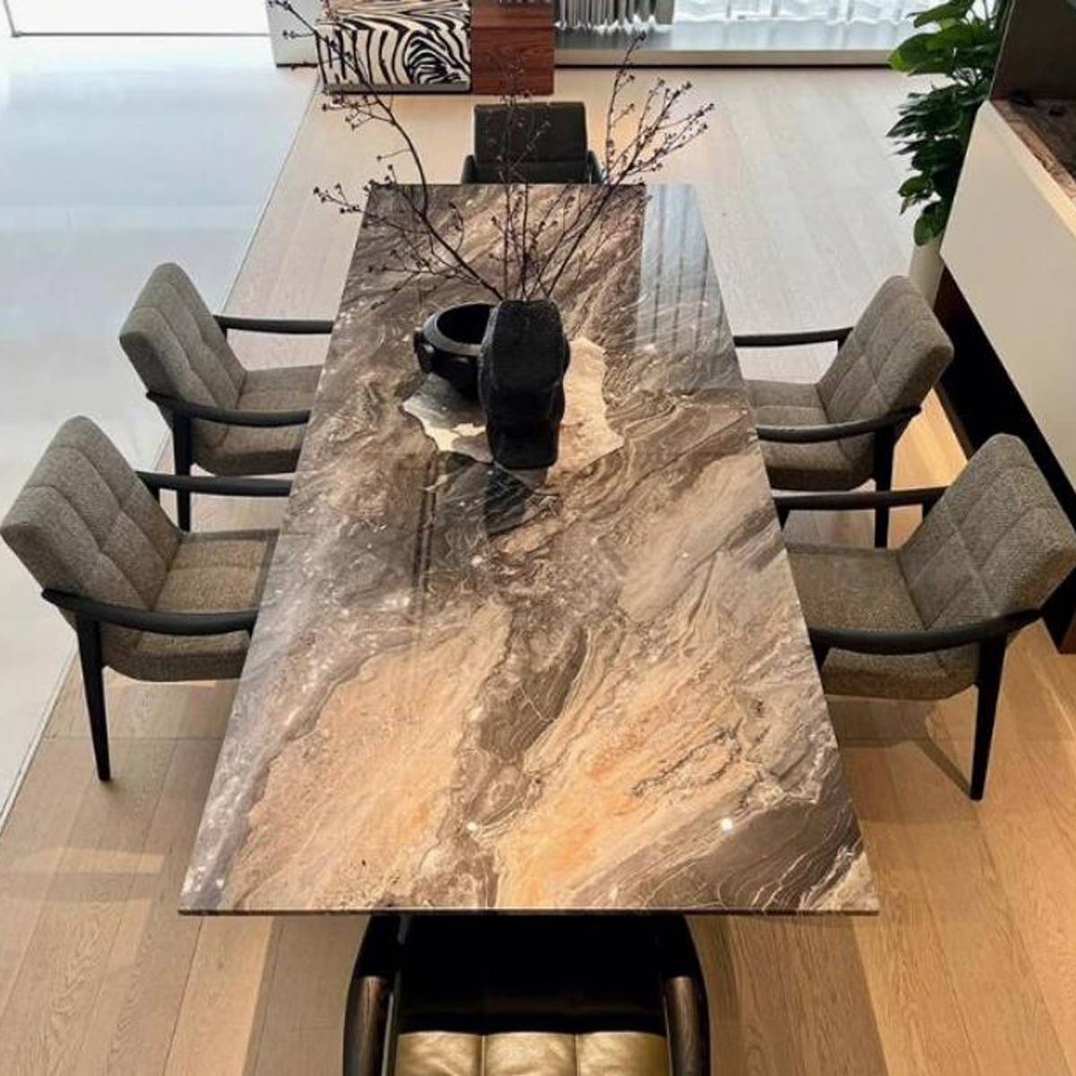 Top-down view of the marble dining table showing the stone pattern and seating arrangement