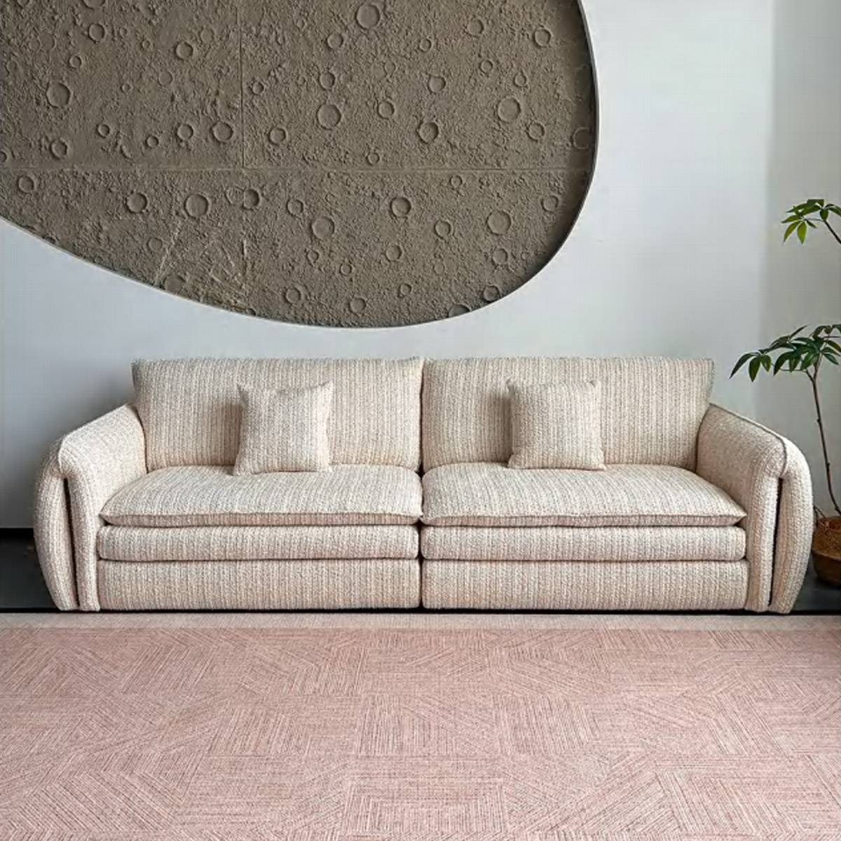 Front view of the beige fabric sofa showing the seat cushions and backrest