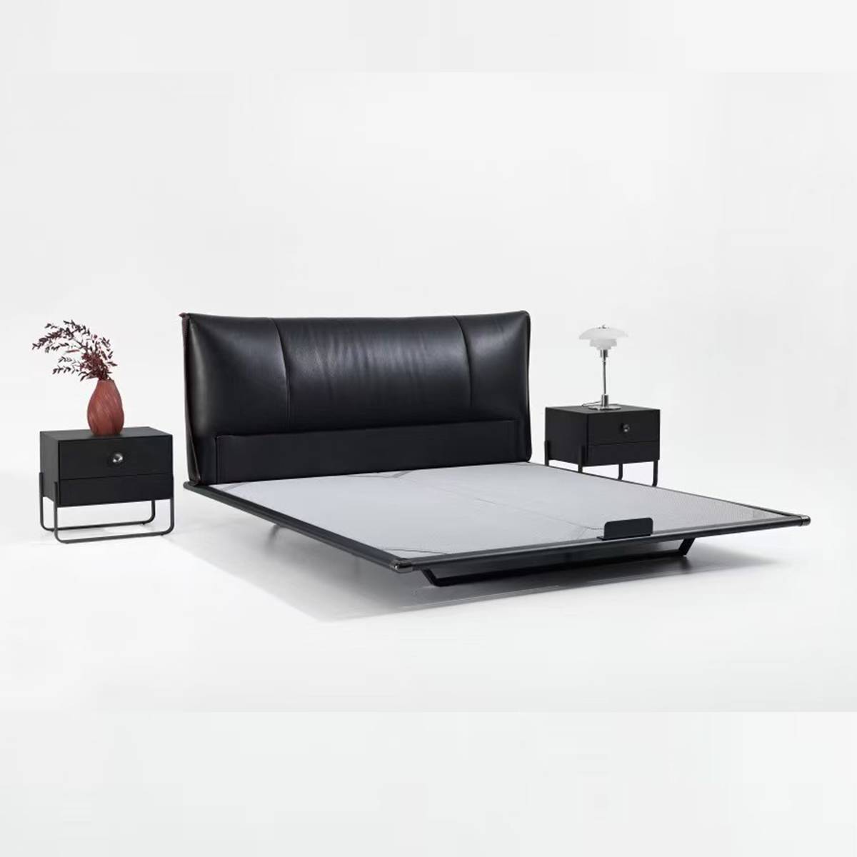 Full view of the black leather bed with floating frame and matching bedside tables