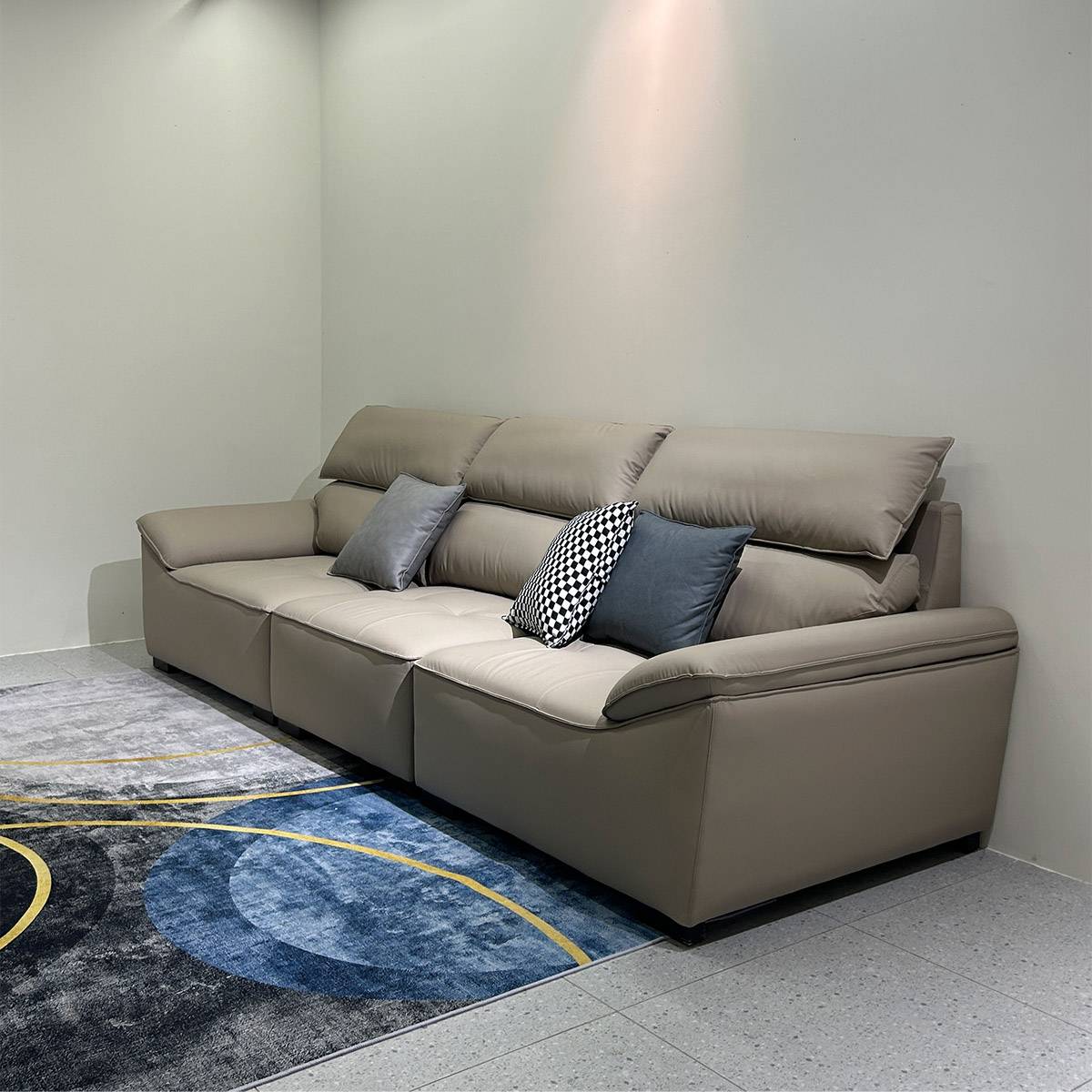 Side view of the beige sofa showing the back cushions and armrests