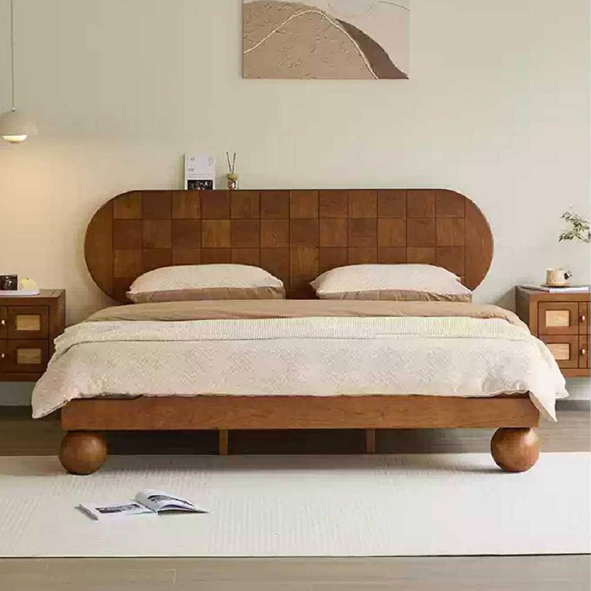 Front view of the bed showing the rounded headboard and spherical legs