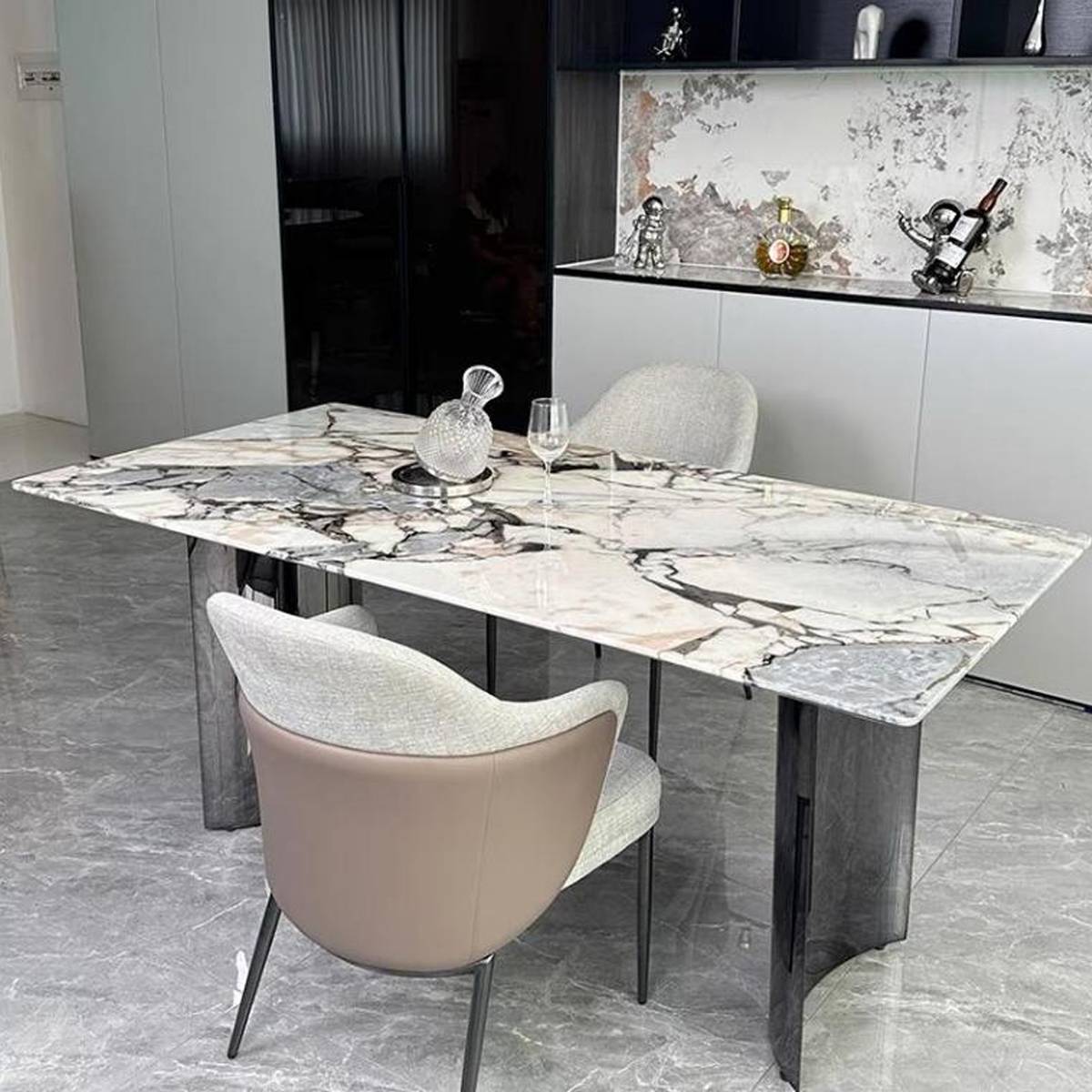 Front view of the marble dining table showing the crescent base design