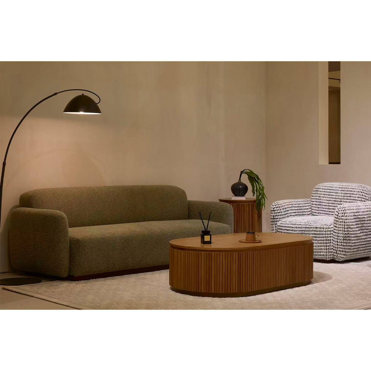 Lifestyle shot of the sofa in a living room setting with a floor lamp and coffee table