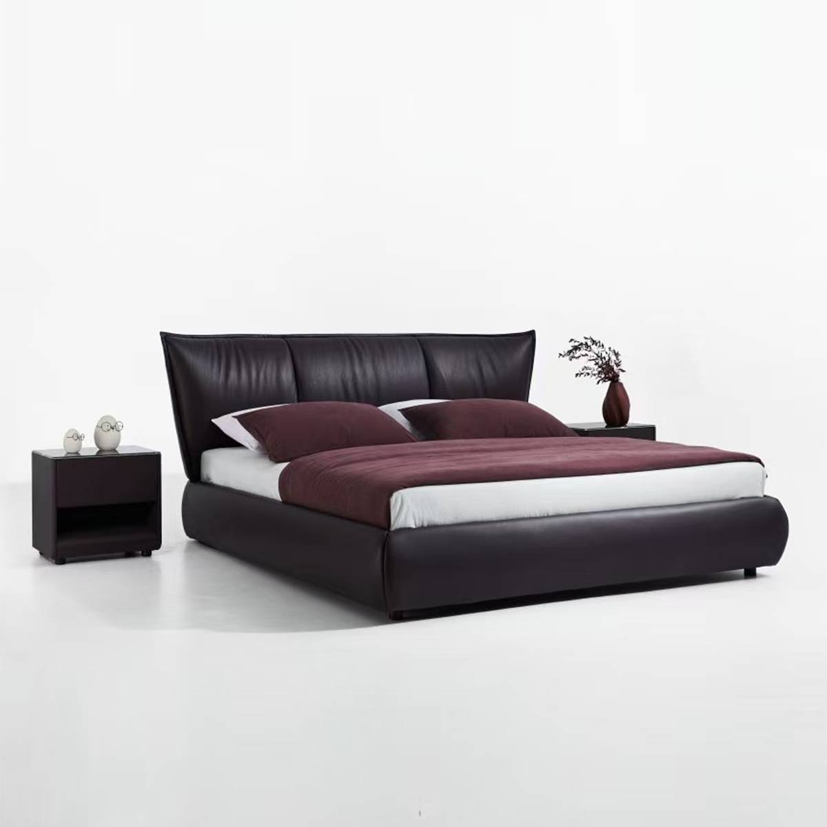Side angle view of the leather bed with bedding