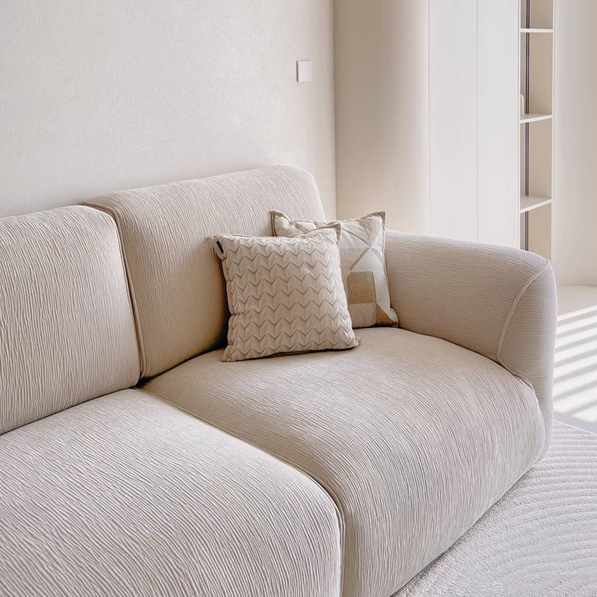 Close-up detail of the sofa's textured fabric and back cushions