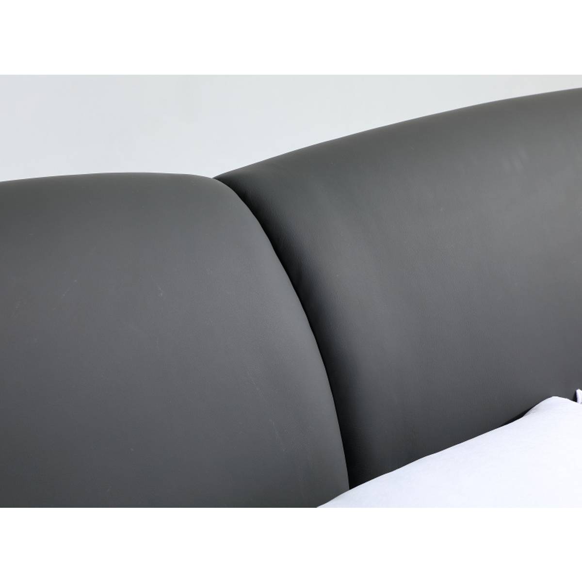 Close-up of the grey leather headboard section