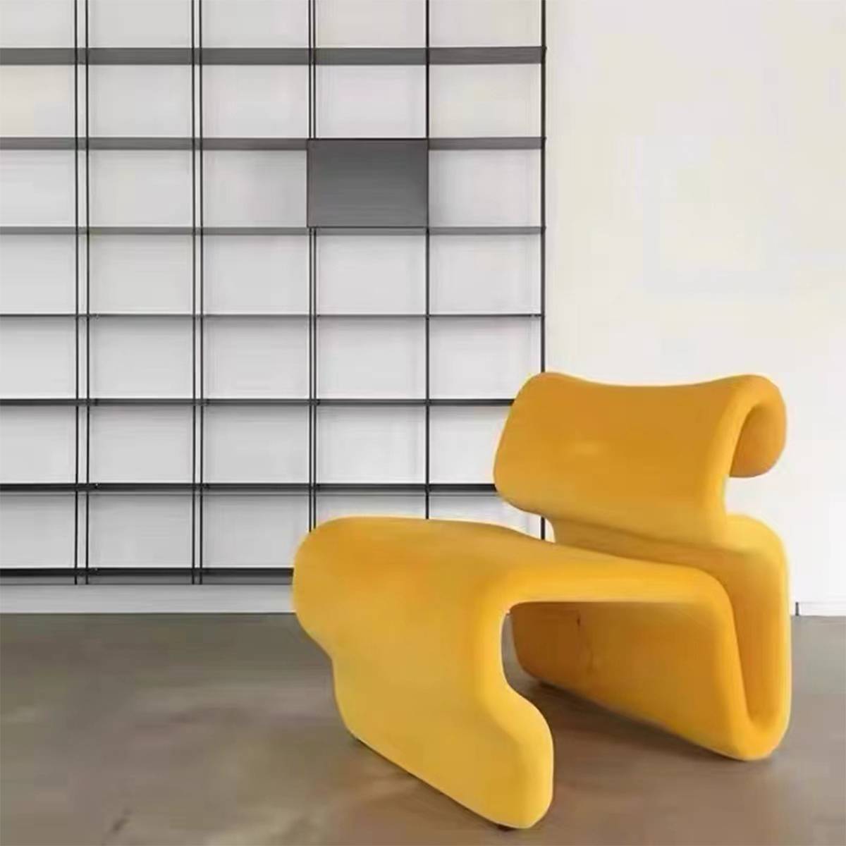 Yellow modern curved lounge chair in room setting