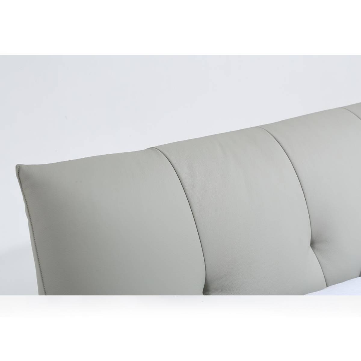 Close-up detail of the grey cowhide headboard showing the tufted stitching and texture.