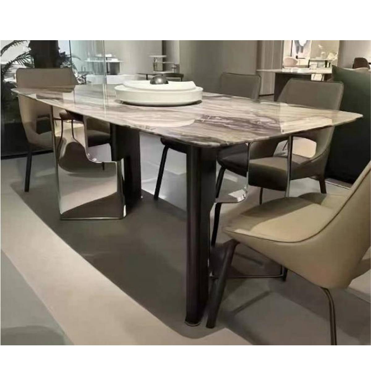 Close-up angle of the marble dining table showing the stainless steel base and marble texture