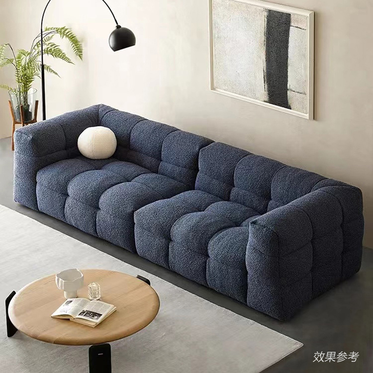 Blue tufted sofa in a modern living room setting