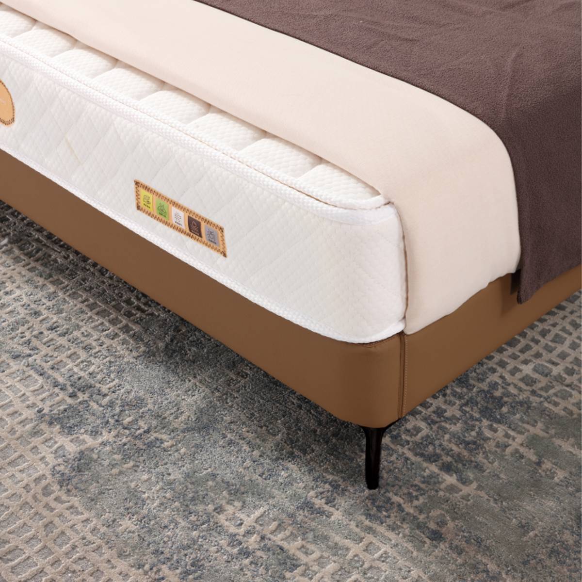 Close-up of the mattress and bed frame corner showing the leg detail