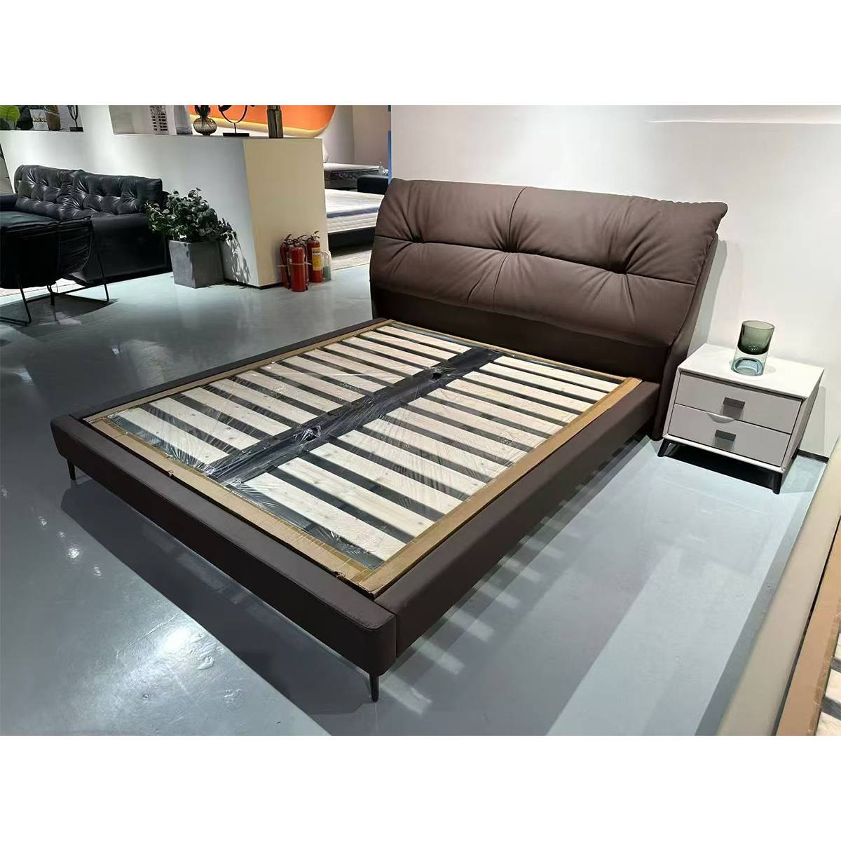 Side angle view of the bed frame showing the slat structure and headboard