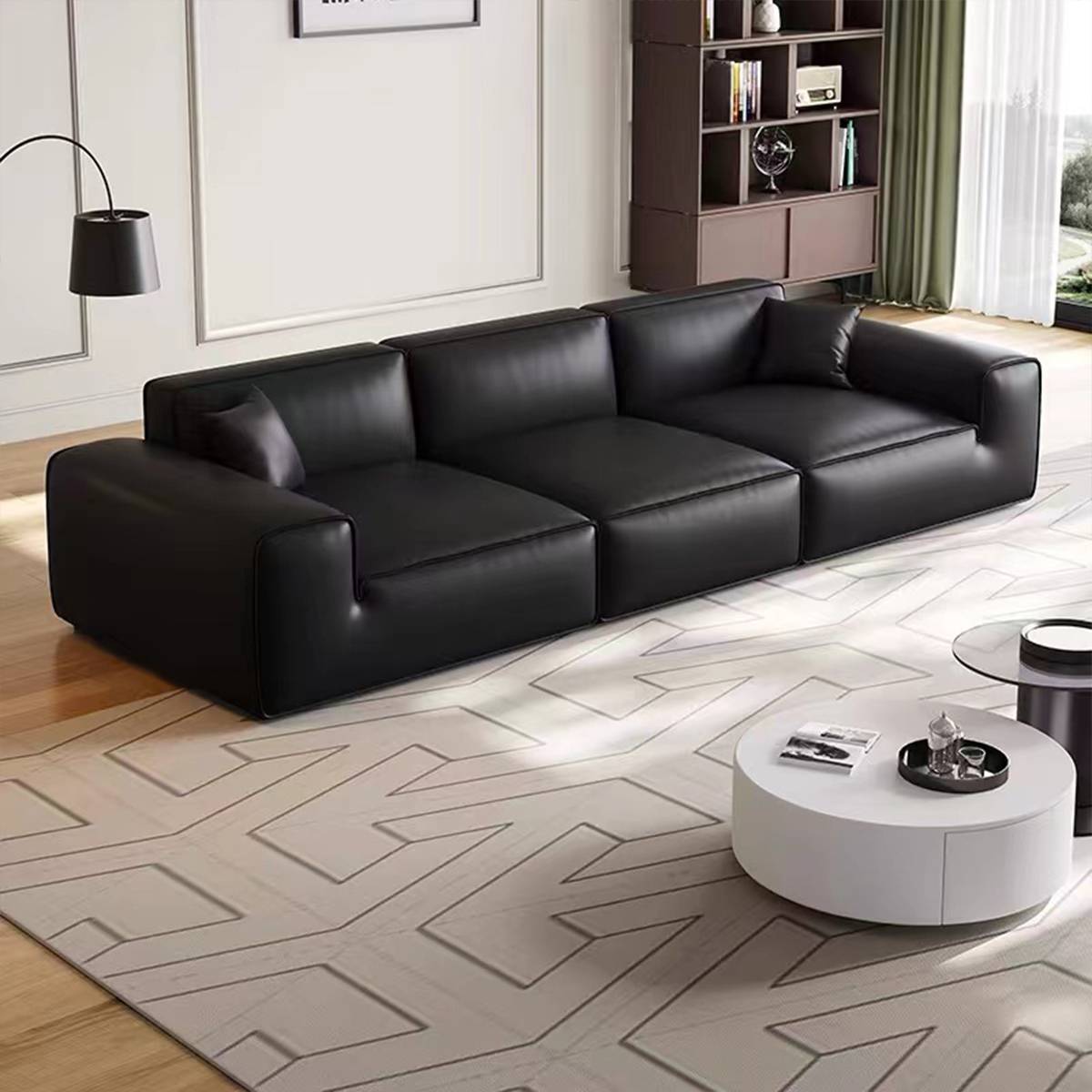 Full view of the black leather sofa in a modern living room setting