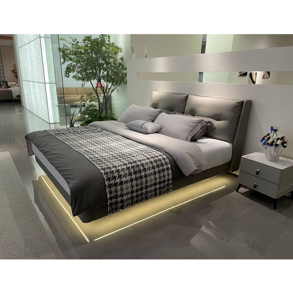 Angle view of the bed showing the headboard and bedding