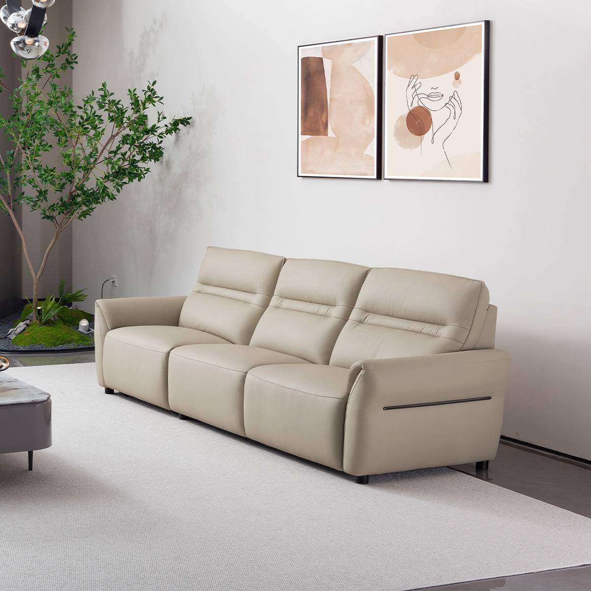 Side view of the beige leather sofa showing the recliner mechanism handle