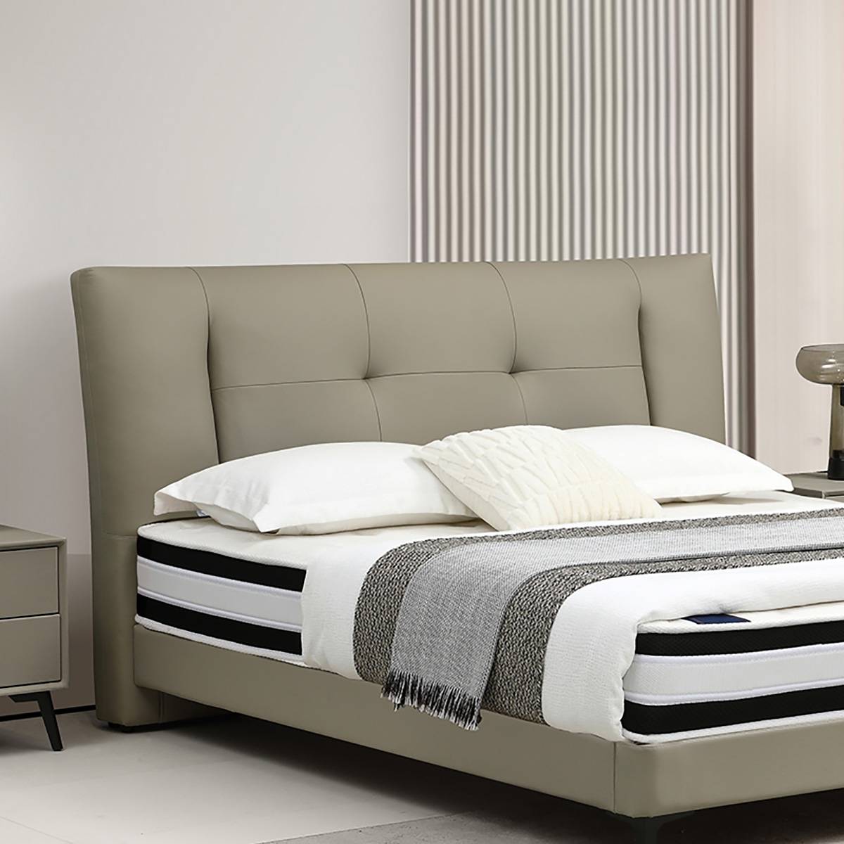 Close-up of the tufted leather headboard and bedding.