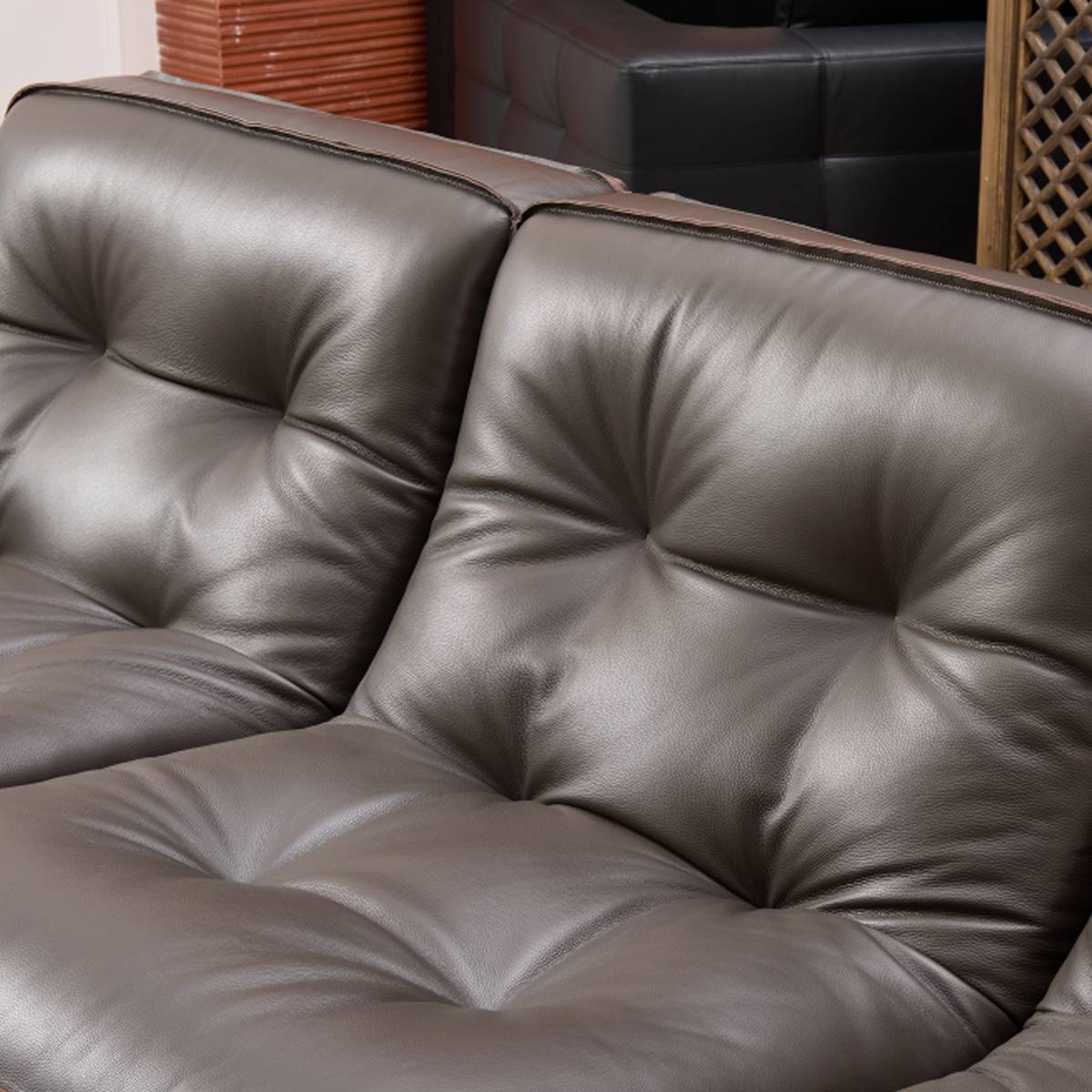 Close-up view of the tufted leather backrest showing texture and stitching details