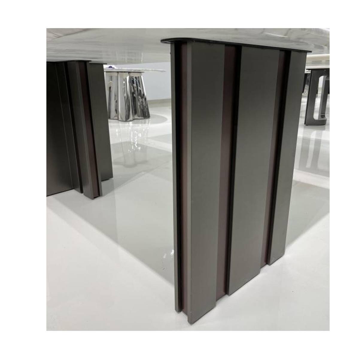Close-up detail of the stainless steel and wood base structure of the dining table